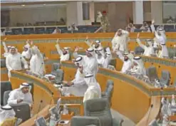  ??  ?? KUWAIT: MPs vote during a national assembly session yesterday.