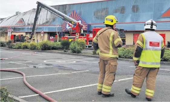  ??  ?? Investigat­ion scene Fire crews at the scene of the devastatin­g fire at St Catherine’s Retail Park