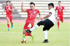  ??  ?? TUSSLE FOR THE BALL ... Sabah striker Fazili Jamileh (left) dispossess a T-Team defender in the President Cup Group B tie at the Likas Stadium yesterday. - Photo courtesy of Jaiman Taip.