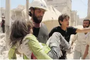  ?? KHALED KHATIB/Getty Images ?? Syrian rescue workers carry an injured young girl following a reported airstrike by pro-regime forces in the al-Marja neighbourh­ood of the northern Syrian city of Aleppo on Tuesday.