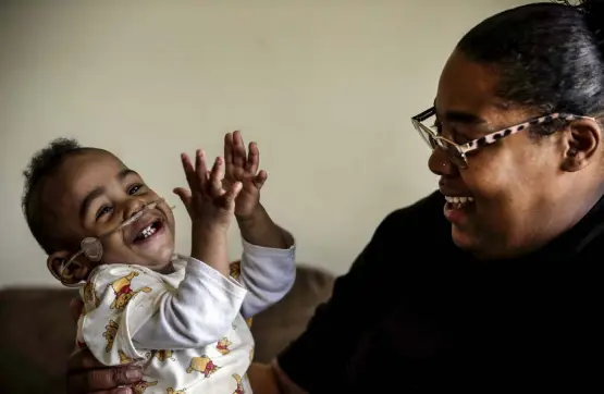  ?? Butch Dill, The Associated Press ?? Curtis Means plays with his mother, Michelle Butler, last month at their home in Eutaw, Ala. After his premature birth, Curtis stayed in the newborn intensive care unit for nine months. Butler made the 90-minute trek from her home in rural Eutaw to Birmingham several times a week. She read books to Curtis and often held him inside her shirt so his skin touched hers.