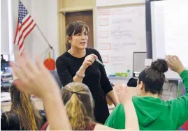  ??  ?? High-school teacher Natalie O’Brien, center, calls on students during a March 8, 2017, civics class called We the People, at North Smithfield High School in North Smithfield, R.I. More states are requiring graduating high-school students to know at least as much about the U.S. founding documents as immigrants passing a citizenshi­p test.