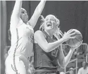  ?? PATRICK FARRELL/TNS ?? Miami’s Emese Hof drives to the basket against past Florida State’s Kiah Gillespie.