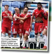  ??  ?? Accrington Stanley players celebrate Adam Phillips’ goal against Portsmouth.