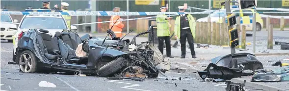  ?? Picture: ANDREW TEEBAY ?? Police inspecting wreckage from the BMW strewn across the road after the Christmas Day crash in which the passenger died – but the driver survived