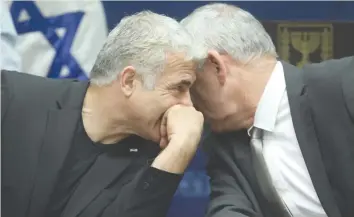  ?? (Marc Israel Sellem/The Jerusalem Post) ?? BLUE AND White leader Benny Gantz consults with Yesh Atid leader Yair Lapid in a faction meeting at the Knesset in 2019.