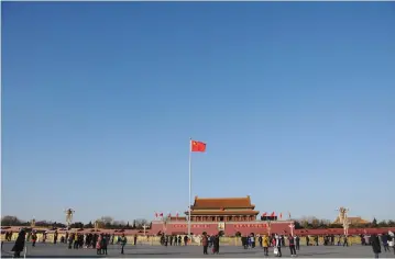  ??  ?? A CHINESE FLAG flutters against blue sky in Tiananmen Square in Beijing last week.