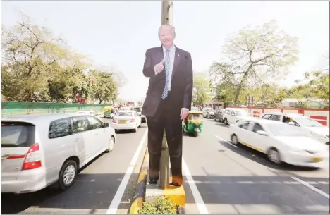  ??  ?? A life size cut-out of US president Donald Trump stands on a road divider, ahead of his visit in Ahmedabad, India on Feb 22. To welcome Trump, who last year likened Modi to Elvis Presley for his crowd-pulling power at a joint rally the two leaders held in Houston, the Gujarat government has spent almost $14 million on ads
blanketing the city that show them holding up their hands, flanked by the Indian and US flags. (AP)