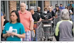  ?? (File Photo/AP/David J. Phillip) ?? People wait for an H-E-B grocery store to open March 17 in Spring, Texas. Grocery store executives and city officials reassured the community that plenty of food will be available in their stores and urged people not to stockpile groceries amid coronaviru­s concerns.