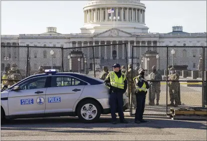  ?? JOHN MINCHILLO — AP PHOTO ?? Fencing was placed around the exterior of the Capitol grounds Thursday morning after a pro-Trump mob stormed the building Wednesday.