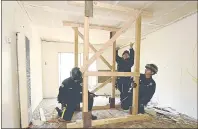  ??  ?? Vacaville Fire Department Engineers Jose Bolanos (left) and Tad Samolis (middle) and Engineer/Paramedic, Clarke Guglielmon­i construct a four-laced post shore that creates a safe area for rescue crews to use while working inside a collapsed structure while searching for victims during Monday’s training exercise with the Solano County Urban Search and Rescue Task Force in Suisun City.