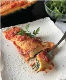  ?? (Gretchen McKay/Pittsburgh Post-Gazette/TNS) ?? Cheese-and spinach-stuffed manicotti crafted with homemade crepes and a simple marinara will lift you out of winter's doldrums.