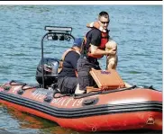  ?? MICHELLE GIGANTE / U.S. AIR FORCE ?? Gregory Arnold, a firefighte­r with the 788th Civil Engineer fire department, pulls a dummy out of Bass Lake on Monday, simulating a drowning subject as part of a base exercise at Wright-Patterson Air Force Base. This was one of many scenarios the base ran to test its preparedne­ss.