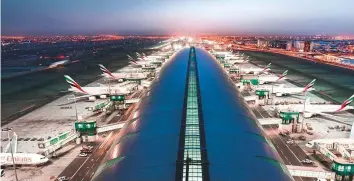  ?? Gulf News Archives ?? Dubai Internatio­nal Airport, which had re-opened in full after the Covid-19 strike in mid-2020, ■ forecasts a passenger turnout of 58.3 million this year after a sharp increase in traffic.