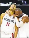  ?? K.C. ALFRED U-T ?? San Diego State’s Matt Mitchell and Adam Seiko celebrate winning the Mountain West Tournament on Saturday.