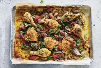  ?? MALOSH/THE NEW YORK TIMES FOOD STYLED BY SIMON ANDREWS. PHOTOS BY DAVID ?? Sheet-pan chicken with rhubarb and red onion in New York on May 12. This easy, jewel-tone roast chicken is tangy-sweet, weeknight-fast and full of savory schmaltz.