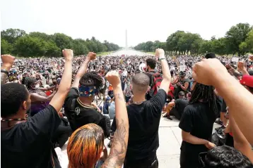  ?? Alex Brandon/Associated Press ?? ■ Demonstrat­ors protest Saturday at the Lincoln Memorial in Washington over the death of George Floyd, a black man who was in police custody in Minneapoli­s. Floyd died after being restrained by Minneapoli­s police officers.