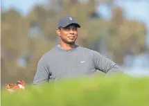  ??  ?? Tiger Woods prepares to tee off on the eighth tee during the first round of the Farmers Insurance Open at Torrey Pines North on Thursday.