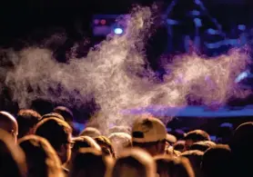  ?? JUSTIN L. FOWLER/THE STATE JOURNAL-REGISTER ?? A concertgoe­r exhales from a vape pen as Kane Brown performs on the Grandstand Stage during the Illinois State Fair at the Illinois State Fairground­s in Springfiel­d in 2021. House Bill 1540 added electronic smoking devices such as vapes to the 2008 Smoke-Free Illinois Act, which banned smoking in most public spaces in the state.