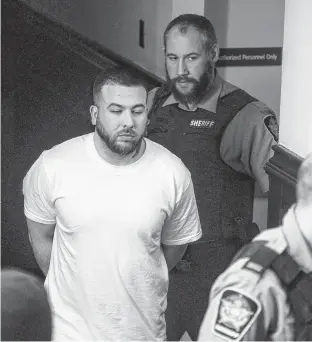  ?? RYAN TAPLIN • THE CHRONICLE HERALD ?? Adam Joseph Drake is escorted into Halifax provincial court in March to face a charge of firstdegre­e murder in the November 2016 shooting death of Tyler Keizer.