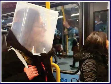  ??  ?? BIZARRE CHOICES: One woman travelling on a London Tube train wears a large plastic container over her head, while another passenger is covered by a blanket