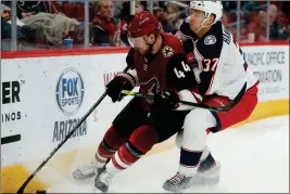  ??  ?? ARIZONA COYOTES defenseman Kevin Connauton (44) shields the puck from Columbus Blue Jackets left wing Markus Hannikaine­n during the third period of a game Thursday in Glendale.