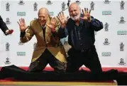  ?? Mark Ralston / AFP | Getty Images ?? Reiner, right, and his father, Carl Reiner, are honored with a hand- and footprint ceremony earlier this month at Grauman’s Chinese Theatre.