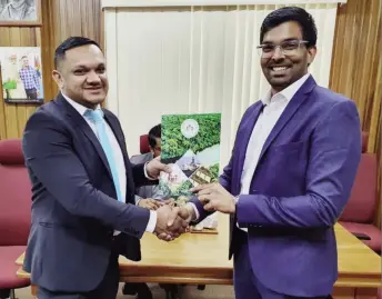  ?? (Ministry of Natural ?? Director of GESGI Jodel Gopeesingh (right) receiving the approved plan from Minister of Natural Resources, Vickram Bharrat.