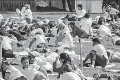  ?? JEENAH MOON AP PHOTO ?? India Prime Minister Narendra Modi practices yoga during the Internatio­nal Yoga Day event at United Nations headquarte­rs in New York. Modi has joined diplomats and dignitarie­s at the United Nations for a morning session of yoga, praising it as “truly universal” and “a way of life.” Modi kicked off the public portion of his U.S. visit at an event honoring the Internatio­nal Day of Yoga.