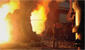  ?? (Reuters) ?? A WORKER OPERATES a furnace at a steel manufactur­ing plant in Hefei, in China’s Anhui province.