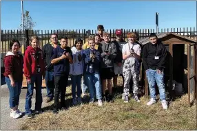  ?? ?? Agricultur­e students pose with chickens as they learn about animal science and raising poultry.