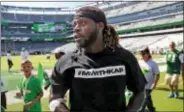  ?? AL DIAZ — MIAMI HERALD VIA AP ?? Dolphins running back Jay Ajayi (23) and several other Dolphin players wear T-shirts in support of Colin Kaepernick before Sunday’s game.