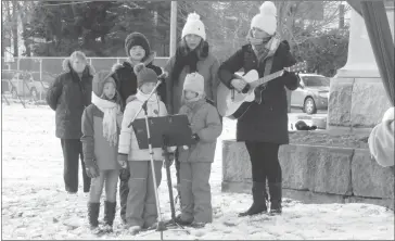  ?? PHOTOS BY ANN DAVIDSON ?? Jessica Brown on guitar and Lucy Hoblyn, choir master of the Knowlton Academy Choir along with some of the choir members sang special tribute to those who have gone to war.