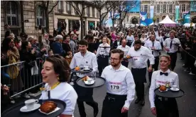  ?? Dilkoff/AFP/Getty Images ?? About 200 waiters took part in the Course des Cafés, in which they had to carry a tray with a coffee, croissant and glass of water in one hand, in Paris on Sunday. Photograph: Dimitar