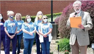  ?? The Sentinel-Record/Tanner Newton ?? Hot Springs Mayor Pat McCabe reads a proclamati­on in recognitio­n of Nurses Week Friday at National Park Medical Center as nurses who are members of the DAISY Award selection committee listen.