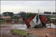  ?? (AP/Str) ?? Shipping containers are left in a jumbled pile by Wednesday floods in Durban, South Africa.