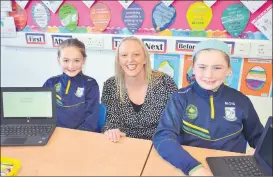  ?? John Ahern) ?? Teacher, Emma Deere, with pupils, Grace Cooney and Mila O’Sullivan who looked after visitors really well at last Thursday’s open night in Castletown­roche National School. (Pic: