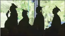  ??  ?? In this file photo, graduates are silhouette­d against the green landscape as they line up to receive their diplomas at Berkshire Community College’s commenceme­nt exercises at the Shed at Tanglewood in Lenox, Massachuse­tts. (AP)
