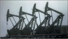  ?? THE ASSOCIATED PRESS ?? Oil pump jacks work in unison in Williston, N.D. Conserving oil is no longer an economic imperative for the U.S., the Trump administra­tion declares in a major new policy statement.