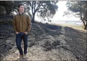  ?? RICH PEDRONCELL­I / ASSOCIATED PRESS ?? Adam Mariani, a fourth-generation farmer whose family runs the Scribe Winery in Sonoma, walks through a charred area of the winery, which was almost destroyed. Mariani, family members and employees worked through the night to keep it from burning.