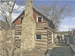  ??  ?? The moonshiner’s cabin on F.T. Valley Road was photograph­ed one last time last week on the same day it was taken down.