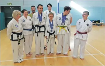  ??  ?? Arran Taekwondo students welcome the returning champions back after their success at the European Championsh­ips.