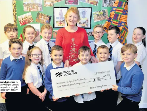  ??  ?? Mary Higgins accepts cheque from pupils at Blacklaw Primary