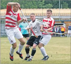  ?? Photograph Donald Cameron. ?? Lovat’s Lorne MacKay is crowded out by Lochaber’s Stuart Callison and Martin Johnstone during the Marine Harvest Premiershi­p match last Saturday.