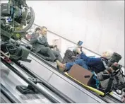  ?? Francois Duhamel Columbia Pictures ?? “SKYFALL” Daniel Craig follows director of photograph­y Roger Deakins down an escalator to the London subway.