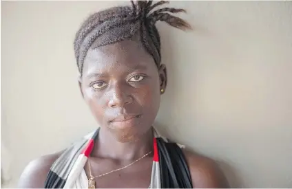  ?? NIKKI KAHN/WASHINGTON POST ?? A pregnant Fatmata Kabia, 21, waits for her baby to be born after surviving Ebola in Port Loko, Sierra Leone. Pregnant women are particular­ly vulnerable to the disease; in every recorded case, mothers with Ebola have passed the disease to their children.