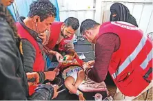  ?? AFP ?? Syrian medics treat a baby at a makeshift clinic at the Internally Displaced Persons (IDP) camp of Al Hol in Hasakeh governorat­e in northeaste­rn Syria on February 6.