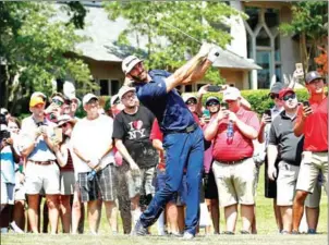  ?? ANDY LYONS/GETTY IMAGES/AFP ?? Dustin Johnson plays his second shot on the 12th hole during the final round of the FedEx St Jude Classic at TPC Southwind on June 10 in Tennessee.