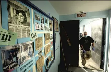  ?? Genaro Molina Los Angeles Times ?? RAMIRO QUEZADA, assistant program director at the Wilmington Teen Center, walks past a wall of clips memorializ­ing Connie Calderon, the center’s longtime director, who died in Dec. 23 at the age of 81.