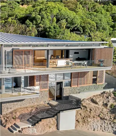  ??  ?? Borrmeiste­r Architects specified sliding timber screens for Red Rock House in Sumner, which won an NZIA Canterbury Housing Award this year. The screens keep out the sun on the hottest days.